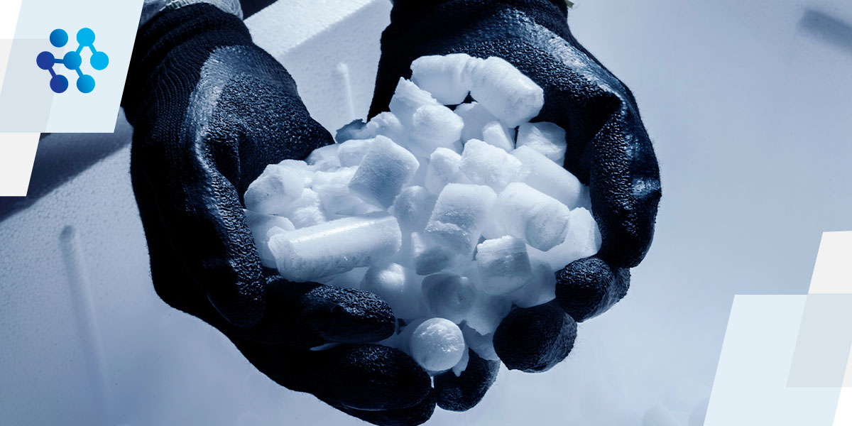 a person wearing black gloves is holding a pile of ice cubes