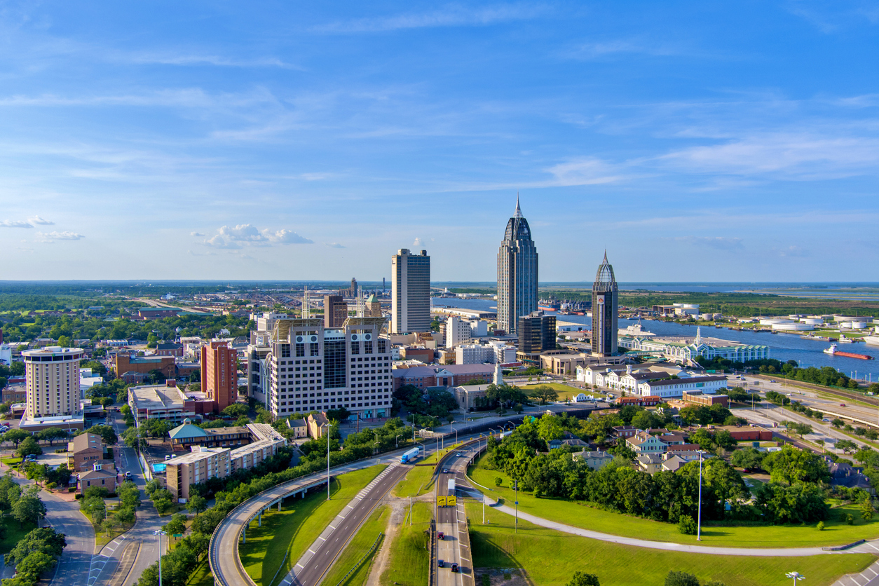 an aerial view of Mobile, Alabama with a highway in the foreground