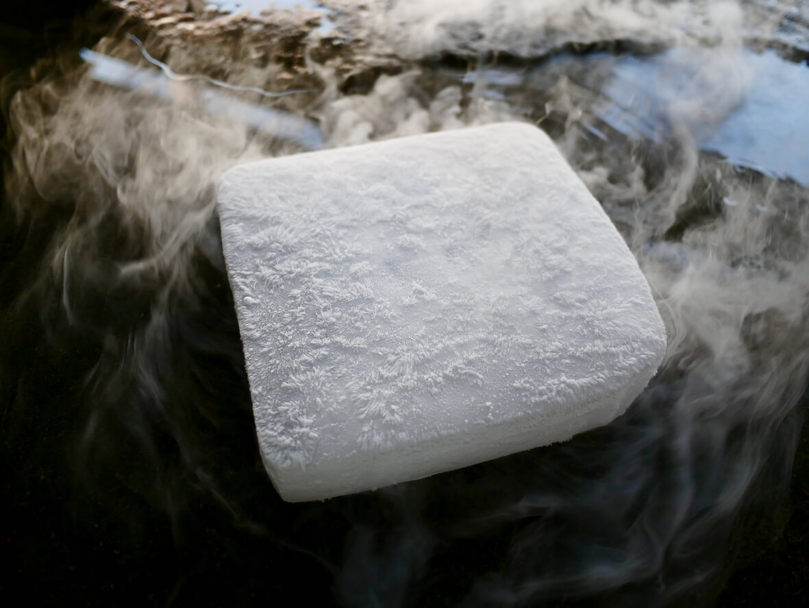 a piece of dry ice is surrounded by smoke