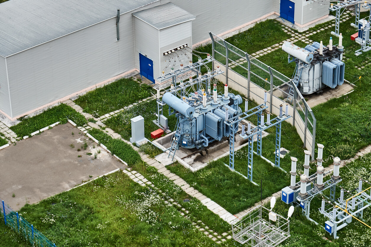an aerial view of a power plant with a transformer in the middle