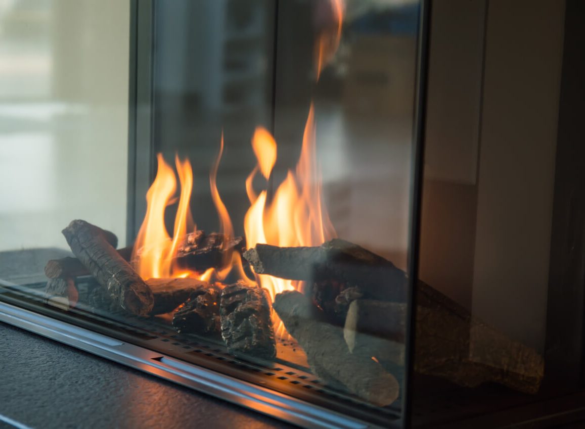 a fireplace with a lot of logs in it