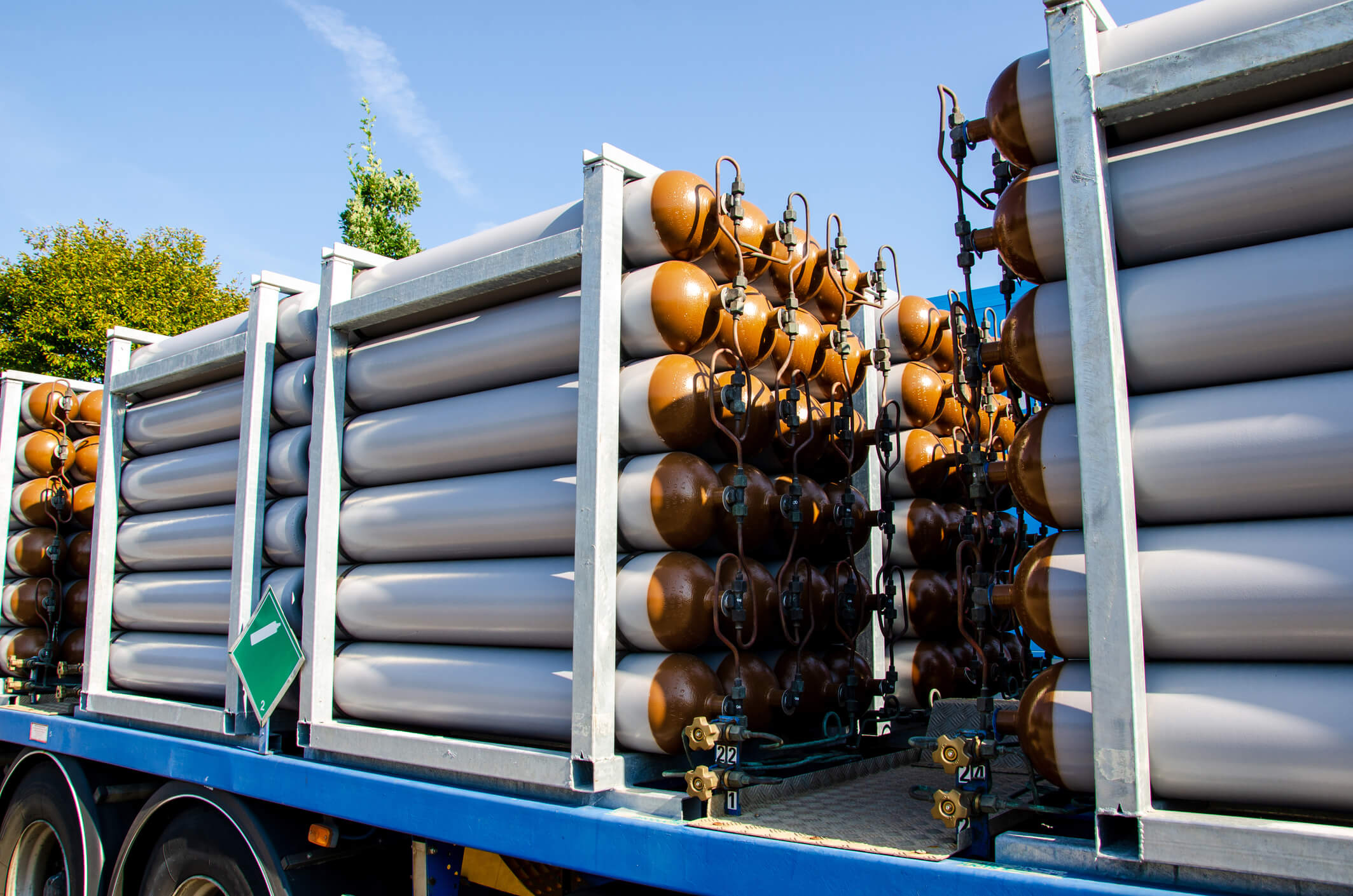 a stack of gas cylinders on a blue truck
