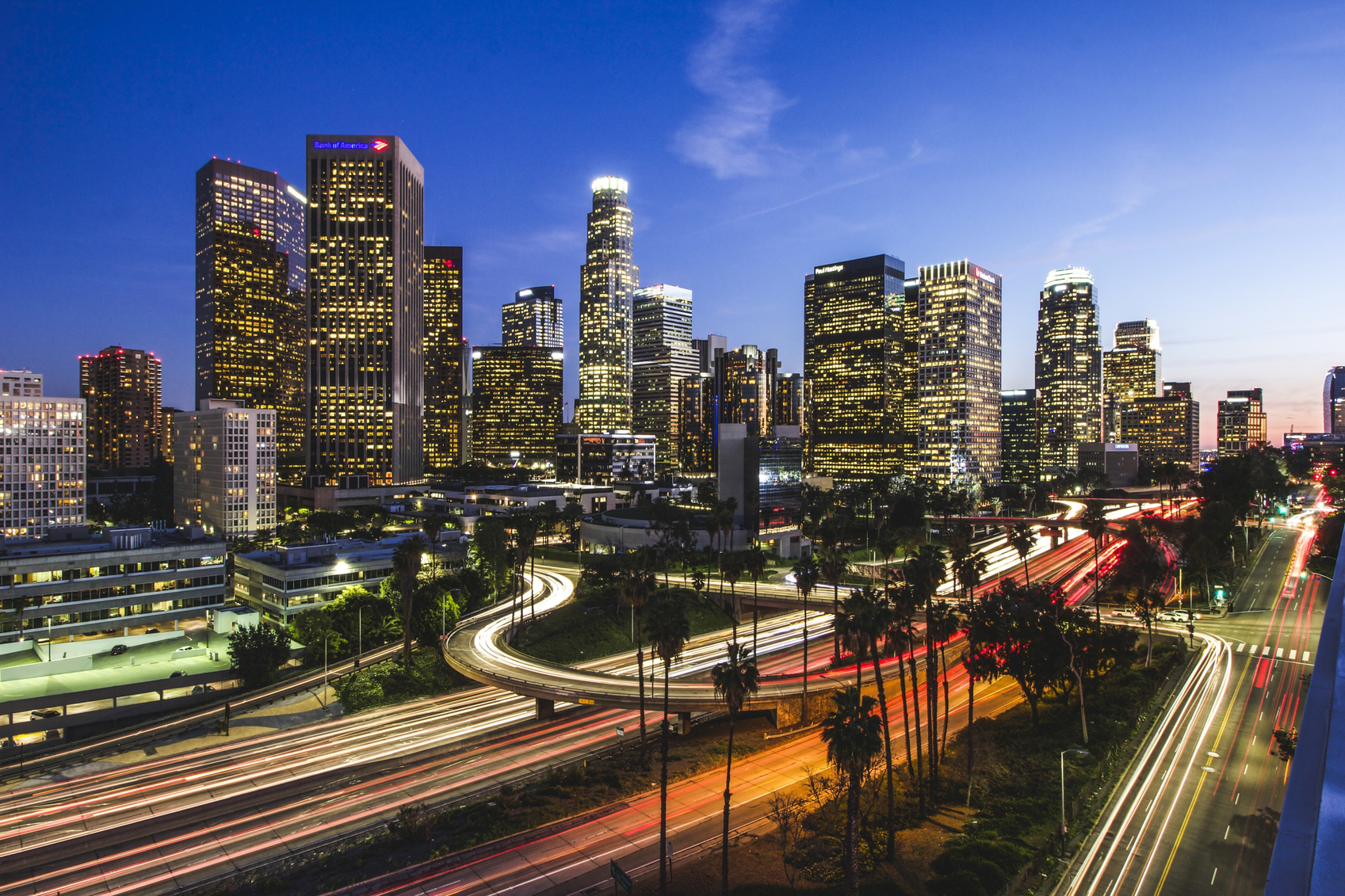 an aerial view of LA at night with a few buildings that have the word chase on them