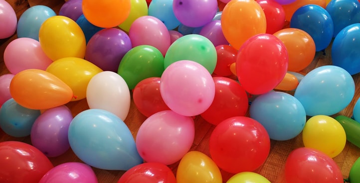 a bunch of colorful balloons are laying on the floor
