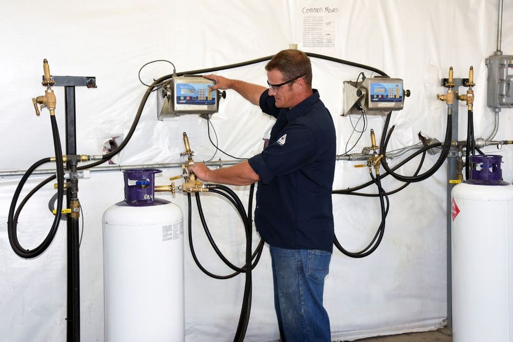 a man in a blue shirt is working on a control panel