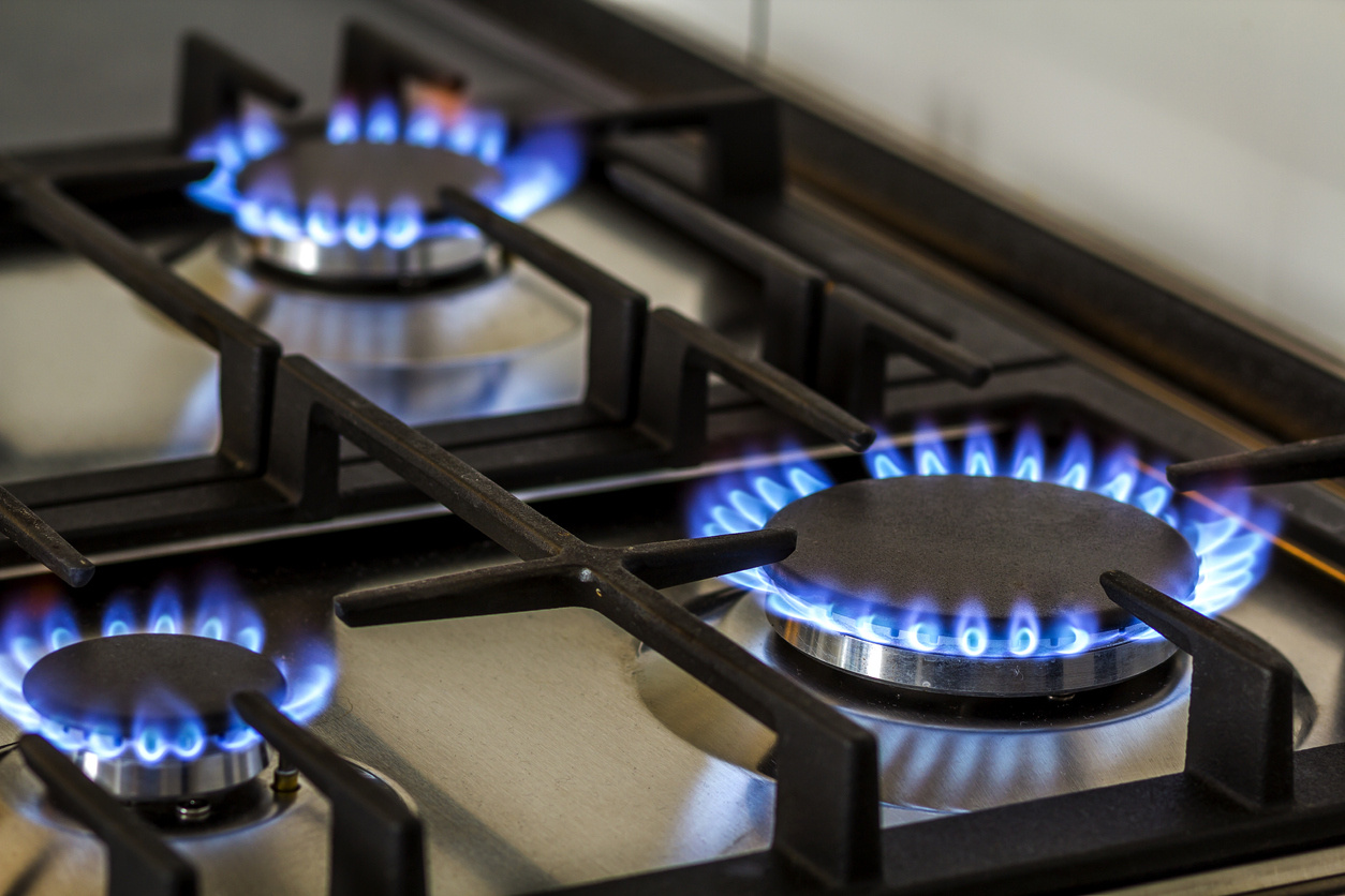 three gas burners are lit up on a stove