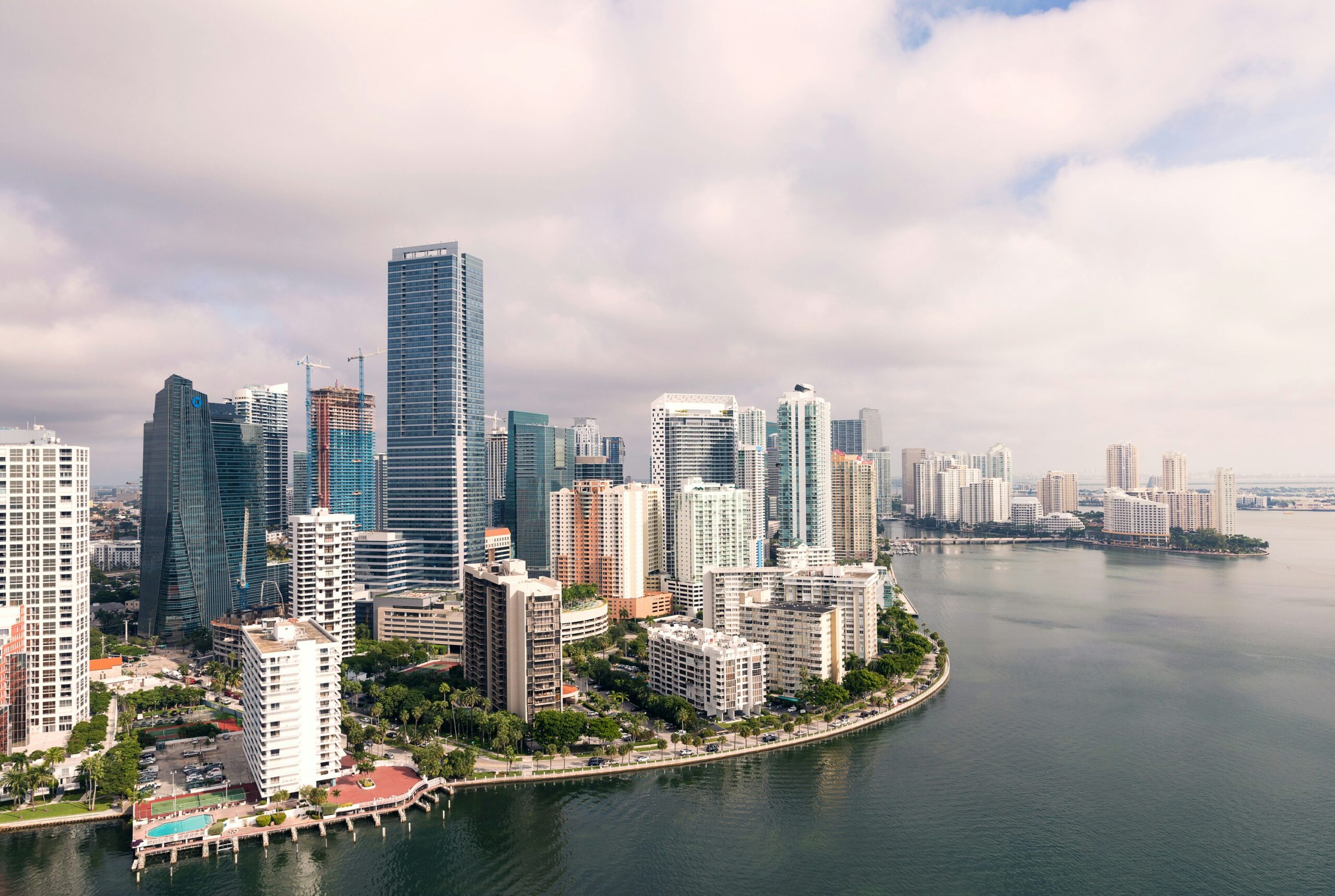 an aerial view of the city of miami with a large body of water in the foreground