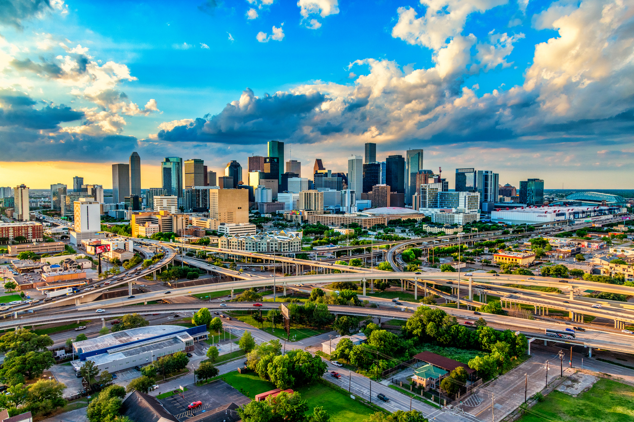 an aerial view of Houston, Texas with a blue sky and clouds