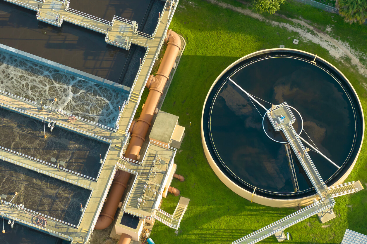 an aerial view of a water treatment plant with a large circular tank in the middle