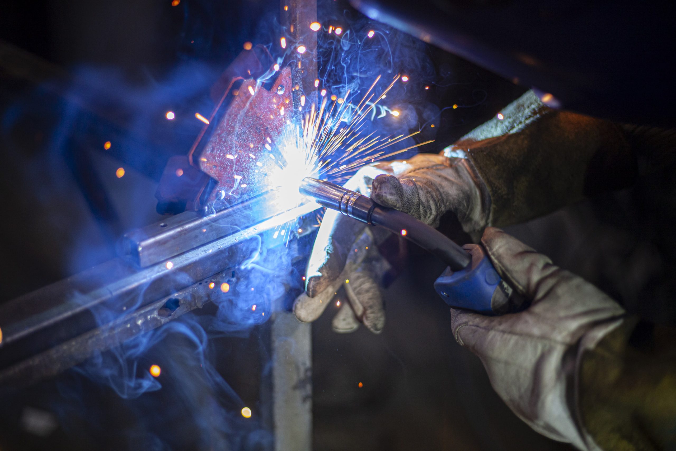 a person is welding a piece of metal with a welding torch