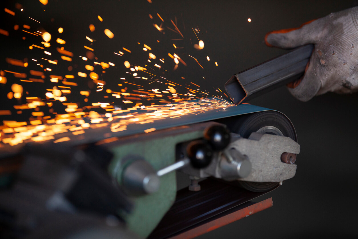 a person is using a machine to grind a piece of metal